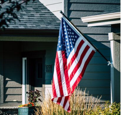 american flag waving outside house photo1 scaled e1749030461904