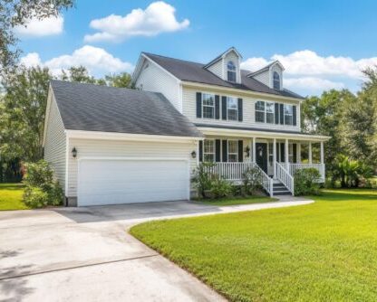 white house with green lawn driveway scaled e1749028340442